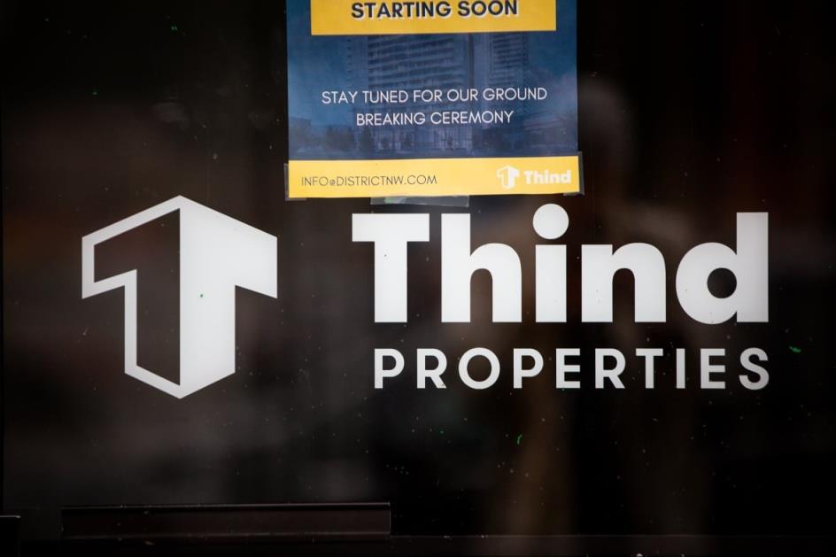 A sign that says Thind Properties.