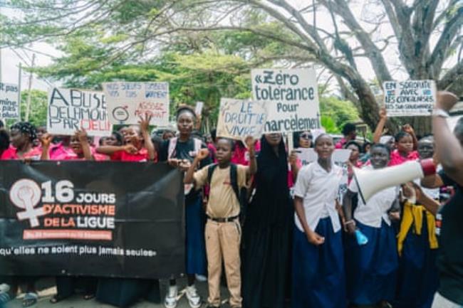 A crowd holding banners and placards written with slogans against rape, sexual violence and femicide