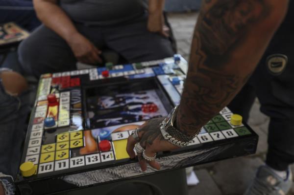 A player moves his piece in poleana, a board game invented in prison, during a tournament in Mexico City last month. Photo: AP