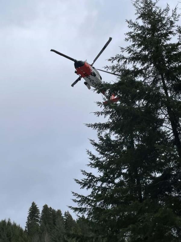 A helicopter flies overhead as officials co<em></em>nduct their search for the men.
