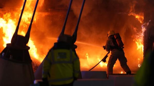 A fire crew tackles a blaze at a merchandise kiosk outside the Etihad Stadium. Pic: PA