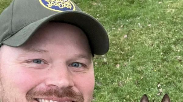 David 'Chris' Maland poses with a police dog