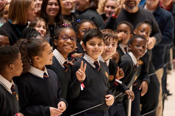 Students from St. George's Primary School smile and pose during their visit to Battersea Power Station.