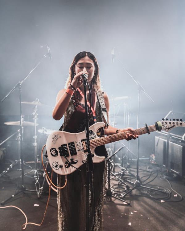 A woman with a guitar.