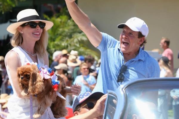 Steve Guttenberg and wife Emily Smith seen as grand marshal for the 76th Pacific Palisades 4th of July Parade on July 4, 2024 in Pacific Palisades, California