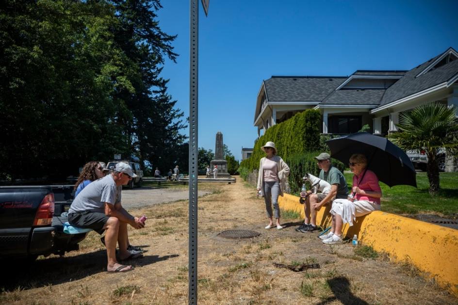 people sit on either side of a sign