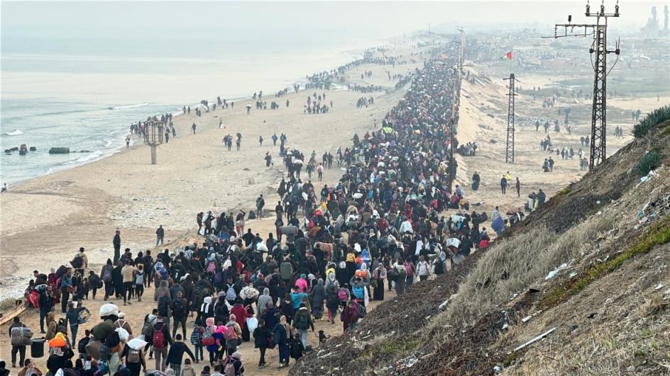 Thousands of people move through main a corridor in Gaza.