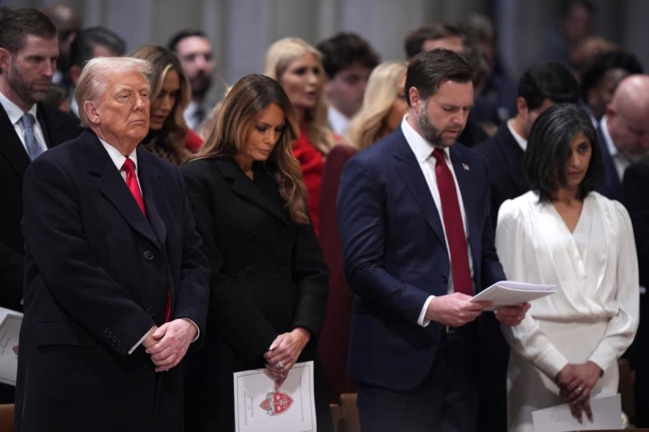 People stand during a prayer service.