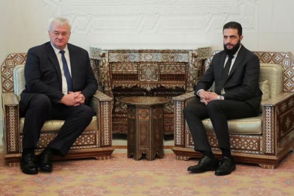 Syria's de facto leader Ahmed al-Sharaa, also known as Abu Mohammed al-Golani looks on as he meets with senior Ukrainian delegation led by Ukrainian Foreign Minister Andrii Sybiha