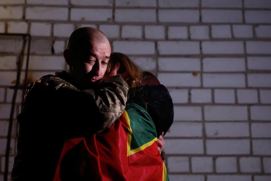 Yevhen, a Ukrainian priso<em></em>ners of war (POW), embraces his wife as he returns after a swap, amid Russia's attack on Ukraine, in an undisclosed location in Ukraine, December 30.