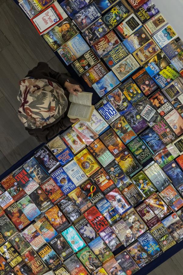A visitor reading a book at the Hills Book Festival.